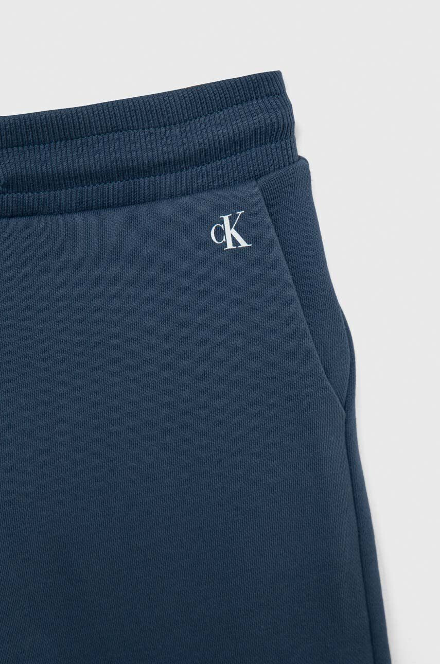 Calvin Klein Jeans Dětské bavlněné tepláky tmavomodrá barva s potiskem - Pepit.cz