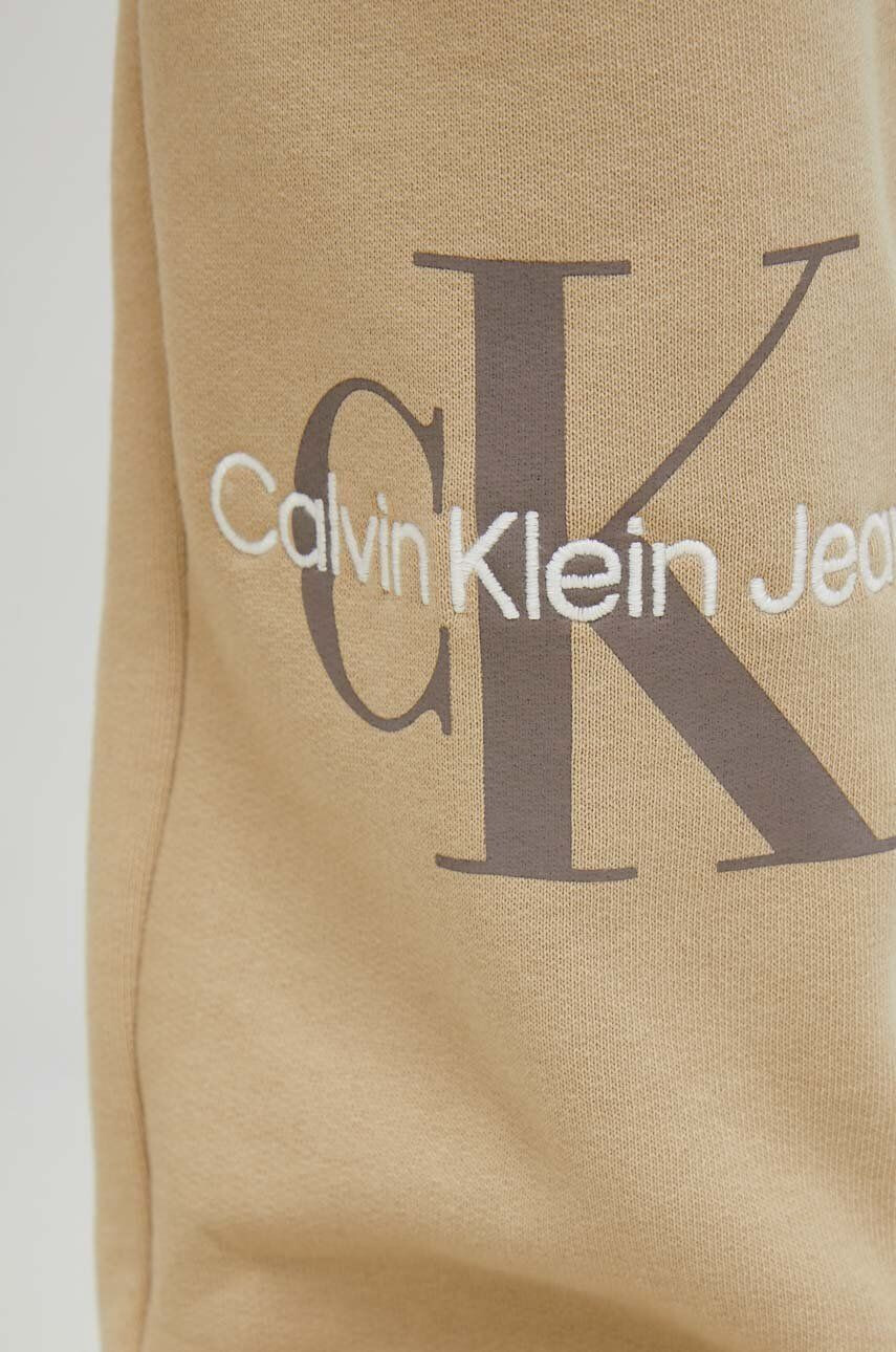 Calvin Klein Jeans Tepláky dámské béžová barva s potiskem - Pepit.cz