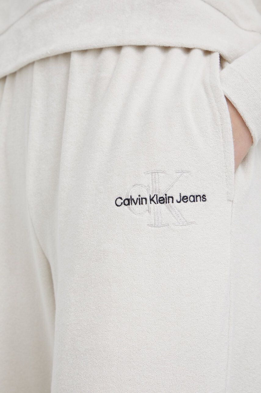 Calvin Klein Jeans Tepláky dámské béžová barva hladké - Pepit.cz