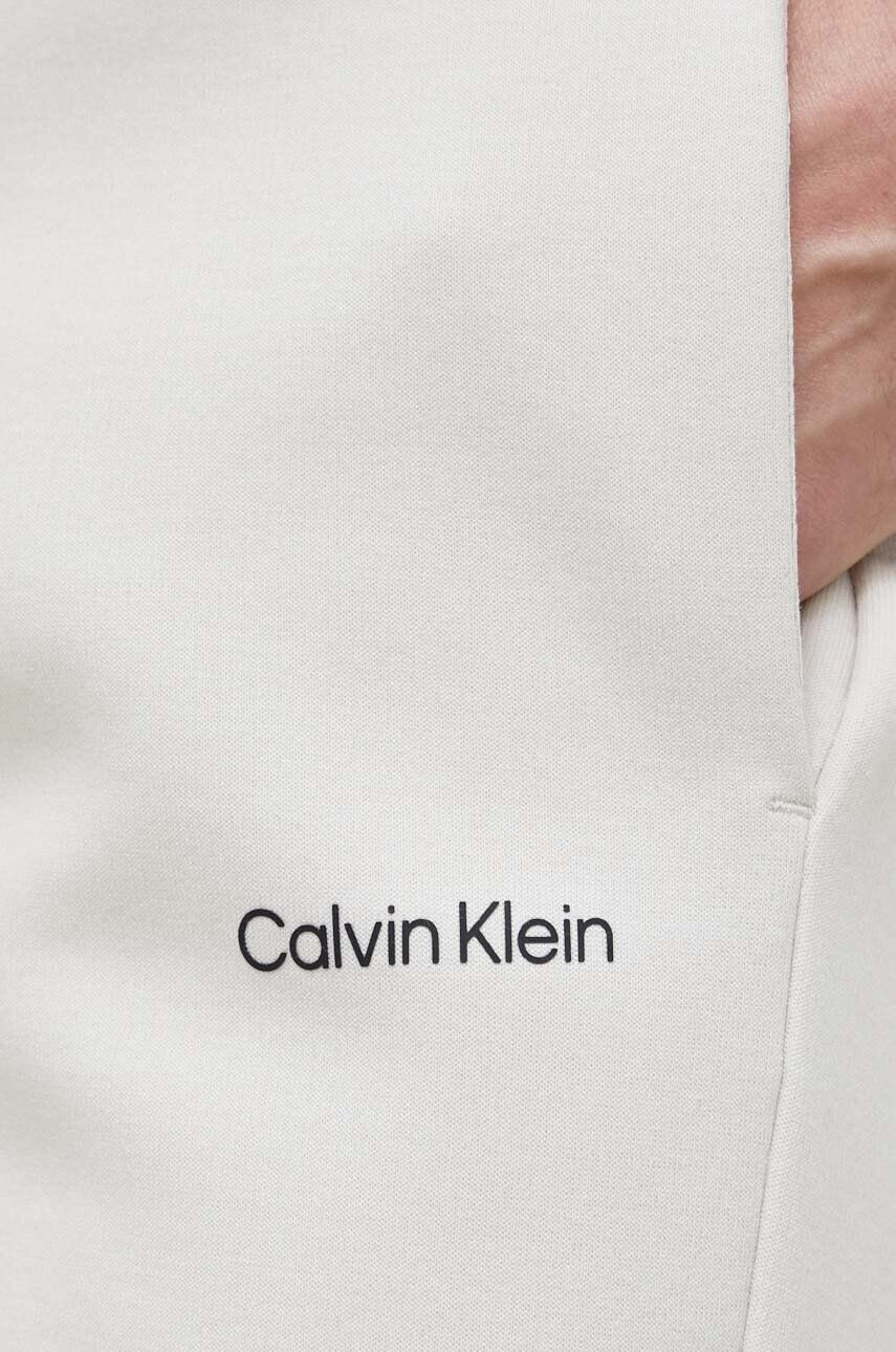 Calvin Klein Tepláky pánské béžová barva hladké - Pepit.cz