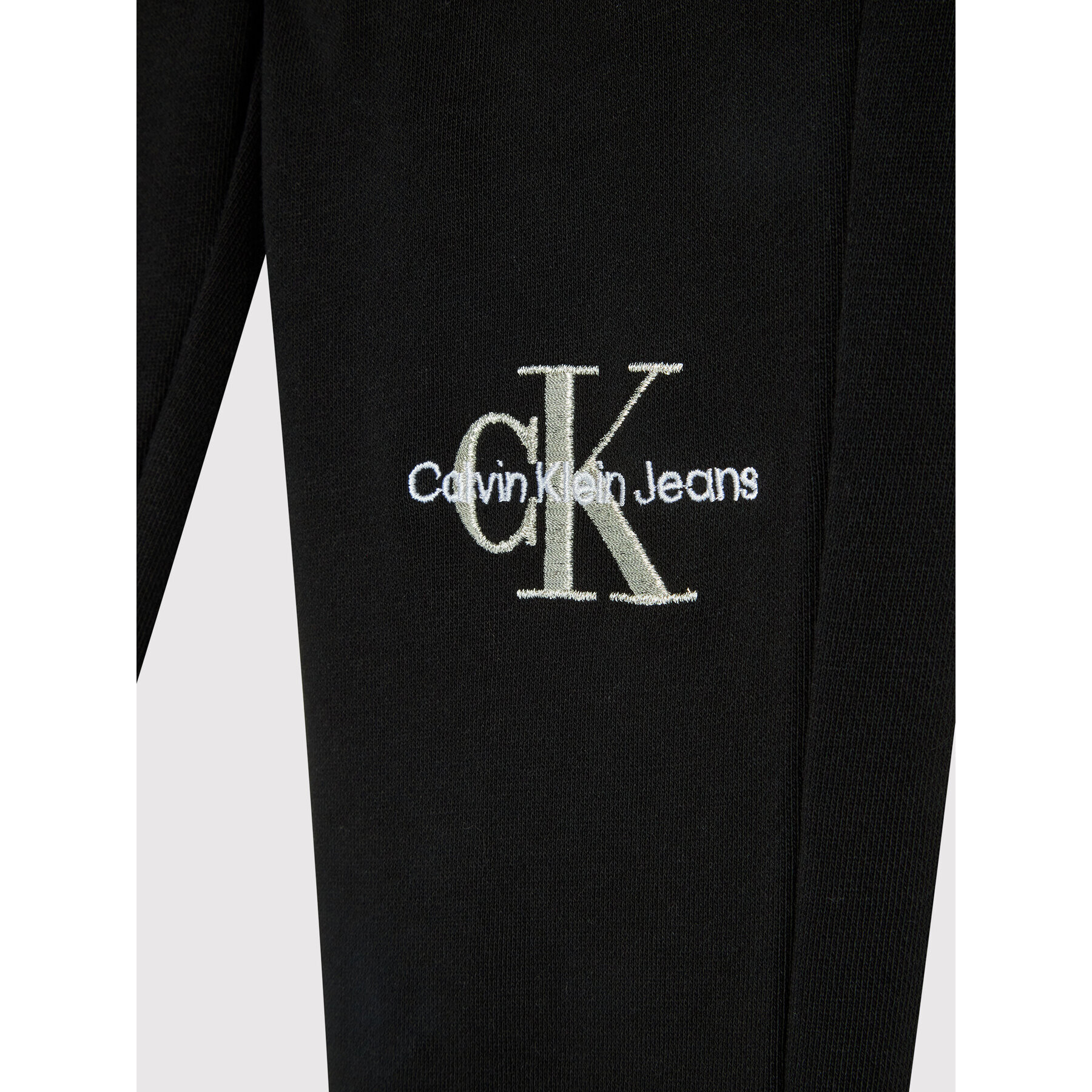 Calvin Klein Jeans Teplákové kalhoty Monogram Off Placed IG0IG01269 Černá Regular Fit - Pepit.cz