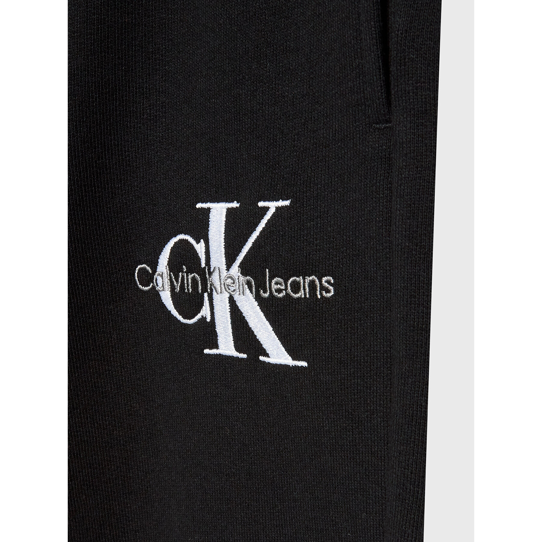 Calvin Klein Jeans Teplákové kalhoty Monogram Off Placed IG0IG01607 Černá Regular Fit - Pepit.cz